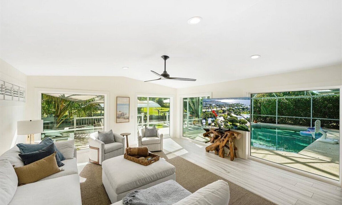 Stuart House | Beautiful 4BR, 3.5BA Stuart retreat with a private screened-in pool. Sleeps 9 and features two en-suite rooms, a modern kitchen, open living, and peaceful canal views perfect for bringing your fishing poles. Minutes to Downtown, dining, and beaches.