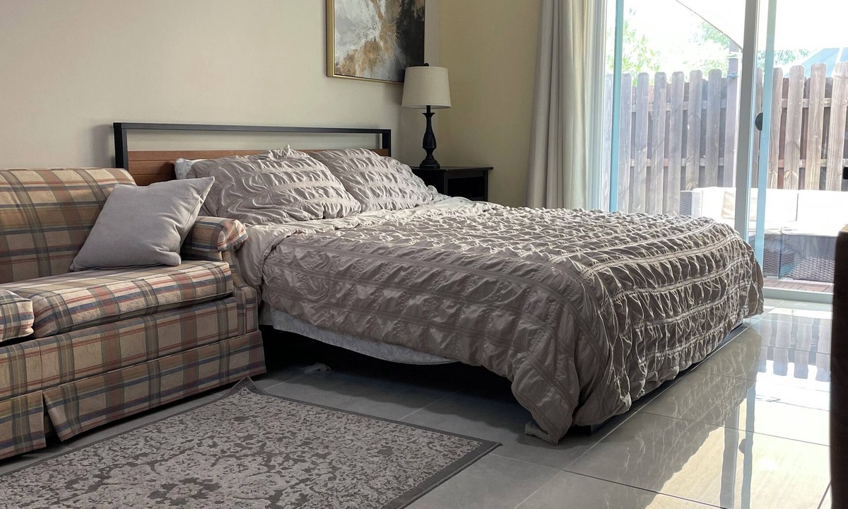Lake Worth Apartment | Cozy room with pool and patio.