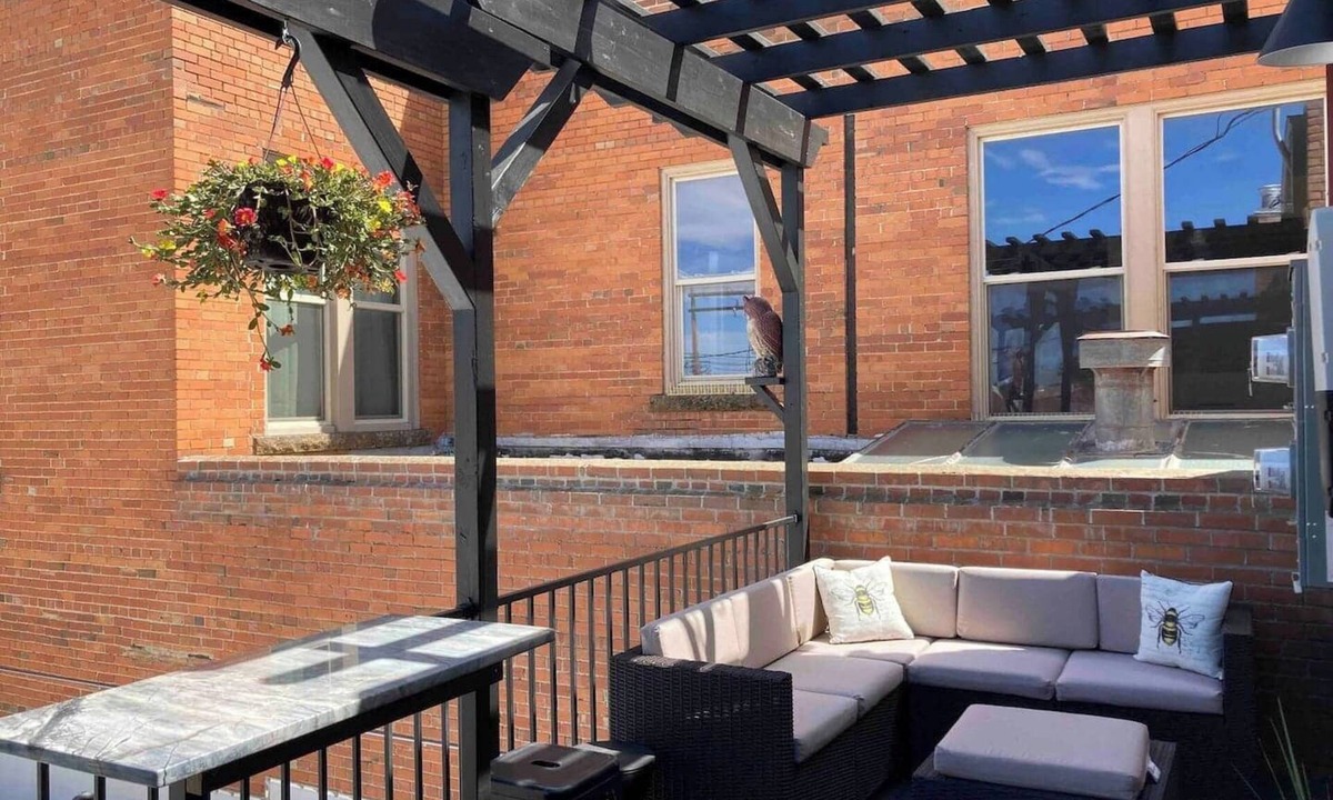 Sheridan Apartment | Luxurious industrial-chic loft in historic downtown Sheridan. This stunning 2-bedroom, 2-bath apartment sleeps up to 9, featuring 2 king suites, 2 1/2 bathrooms sleeping alcove, modern kitchen, fireplace, & Main Street balcony views.