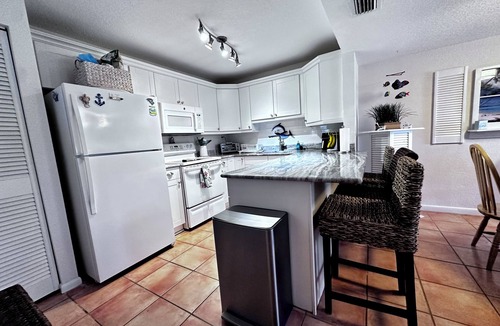 Fort Pierce Condo | 🏖️ 40 Steps to the Beach! Ground Floor Condo . Golf, Pools & Tiki Bar and more.
