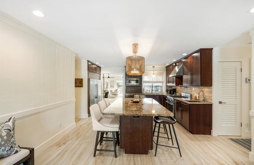 Stuart House | Beautiful 4BR, 3.5BA Stuart retreat with a private screened-in pool. Sleeps 9 and features two en-suite rooms, a modern kitchen, open living, and peaceful canal views perfect for bringing your fishing poles. Minutes to Downtown, dining, and beaches.