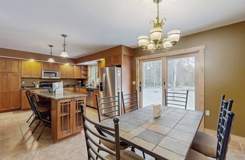 Sunday River Area House | Beautiful log cabin with nearby skiing, large living spaces, and outdoor patio