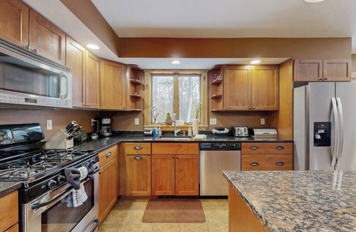 Sunday River Area House | Beautiful log cabin with nearby skiing, large living spaces, and outdoor patio