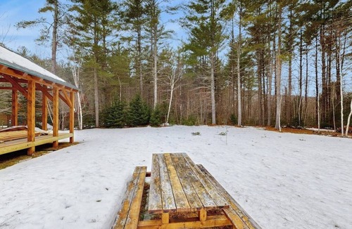 Sunday River Area House | Beautiful log cabin with nearby skiing, large living spaces, and outdoor patio