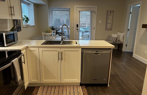 Maple Ridge House | Bright Modern 1 bed suite with garden/pool view.