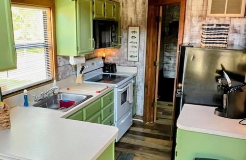 Okeechobee Cabin | Charming gingerbread style lakeside cabin on Lake Okeechobee