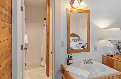 Clark Cabin | Comfortable private queen room in the True North Adventure Lodge. Includes a queen bed, private ensuite bathroom, and access to shared amenities like the kitchen, great room, and hot tub. Great for couples or solo travelers.