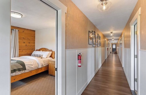 Clark Cabin | Comfortable private queen room in the True North Adventure Lodge. Includes a queen bed, private ensuite bathroom, and access to shared amenities like the kitchen, great room, and hot tub. Great for couples or solo travelers.