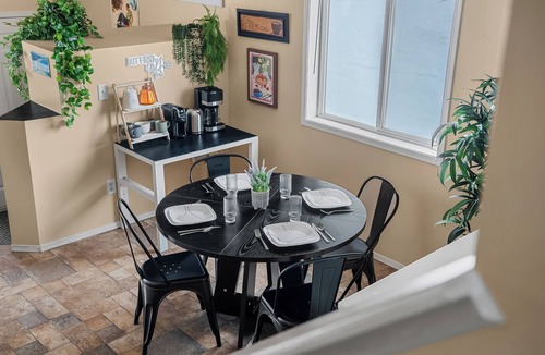 Southeast Edmonton House | Cozy travel-themed retreat near Tamarack shops, dining, games & coffee bar.