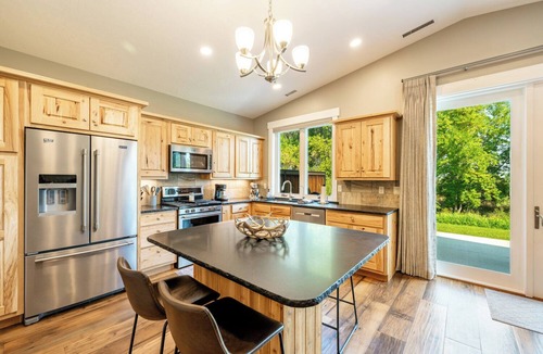 Sheridan Condo | Elegant creekside guest suite in Sheridan's Powderhorn Golf Community. This private, single-level retreat comfortably accommodates four guests, featuring a fully equipped kitchen & an expansive private patio with a BBQ grill overlooking Goose Creek.