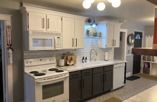 Sheridan Cottage | Escape to this stylish, centrally-located, updated home, perfect for families or groups. Featuring a modern kitchen, private fenced backyard with a gas fire column, and flexible sleeping arrangements for up to 6 guests.