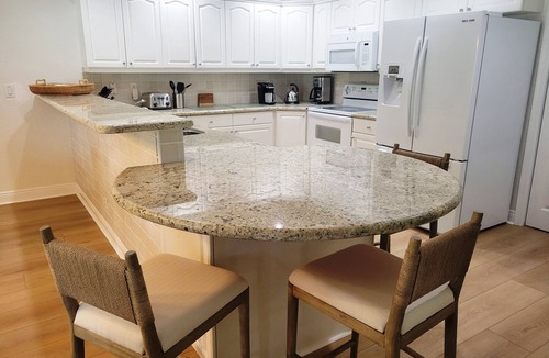Wellington House | Golf cart distance to WEF! Charming 3 bedroom waterfront home with heated pool.