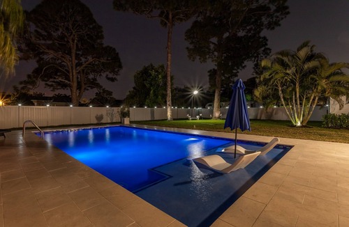 Boynton Beach House | Golfers Green Retreat with 35' Heated Saltwater Pool & Tiki. Pet Friendly!