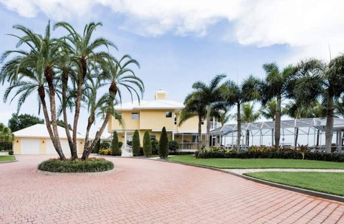 Port Saint Lucie House | Lush Waterfront Pool Home and Pool house with Pickleball court and Boat dock
