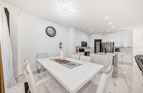 Bridlewood House | Luxury 4 Bedroom detached, vacation home in SW Calgary. King-size bed.