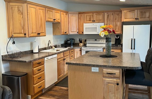 Millcreek House | Open floor plan with a covered patio and fenced yard.