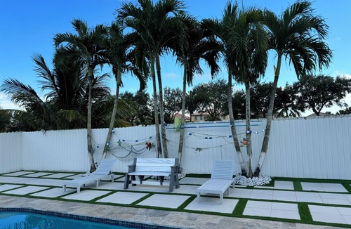 Royal Palm Beach House | Remodeled cozy family house with heated pool, 10 min from the airport!