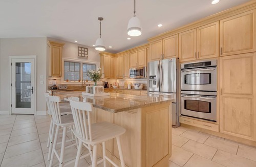 Cape Neddick House | The Hill is a Luxury 5-bedroom retreat with panoramic ocean views from almost every room, just 0.2 miles from Cape Neddick Beach. One-level living with ramp access, roll-in showers, and grab bars makes it ideal for multigenerational beach stays.