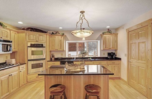 Eagle River Condo | Waterfront townhome with fireplace, private patio, & shared boat docks