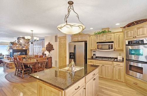 Eagle River Condo | Waterfront townhome with fireplace, private patio, & shared boat docks