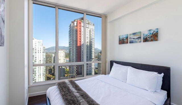 Elevated Coal Harbour living with panoramic harbour & mountain views, steps to Vancouver's iconic waterfront, dining and shopping.